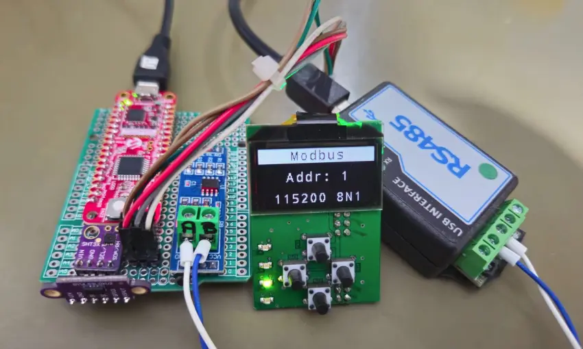 PIC32CM MC00 Curiosity Nano running the demo, with the IHM shield showing a Modbus screen and a USB-RS485 adapter